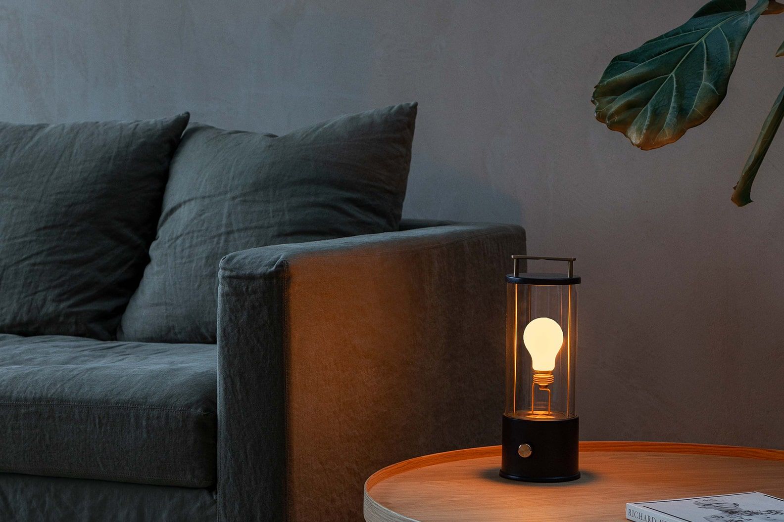 Lamp in a living room on a side table with a fiddle-leaf fig