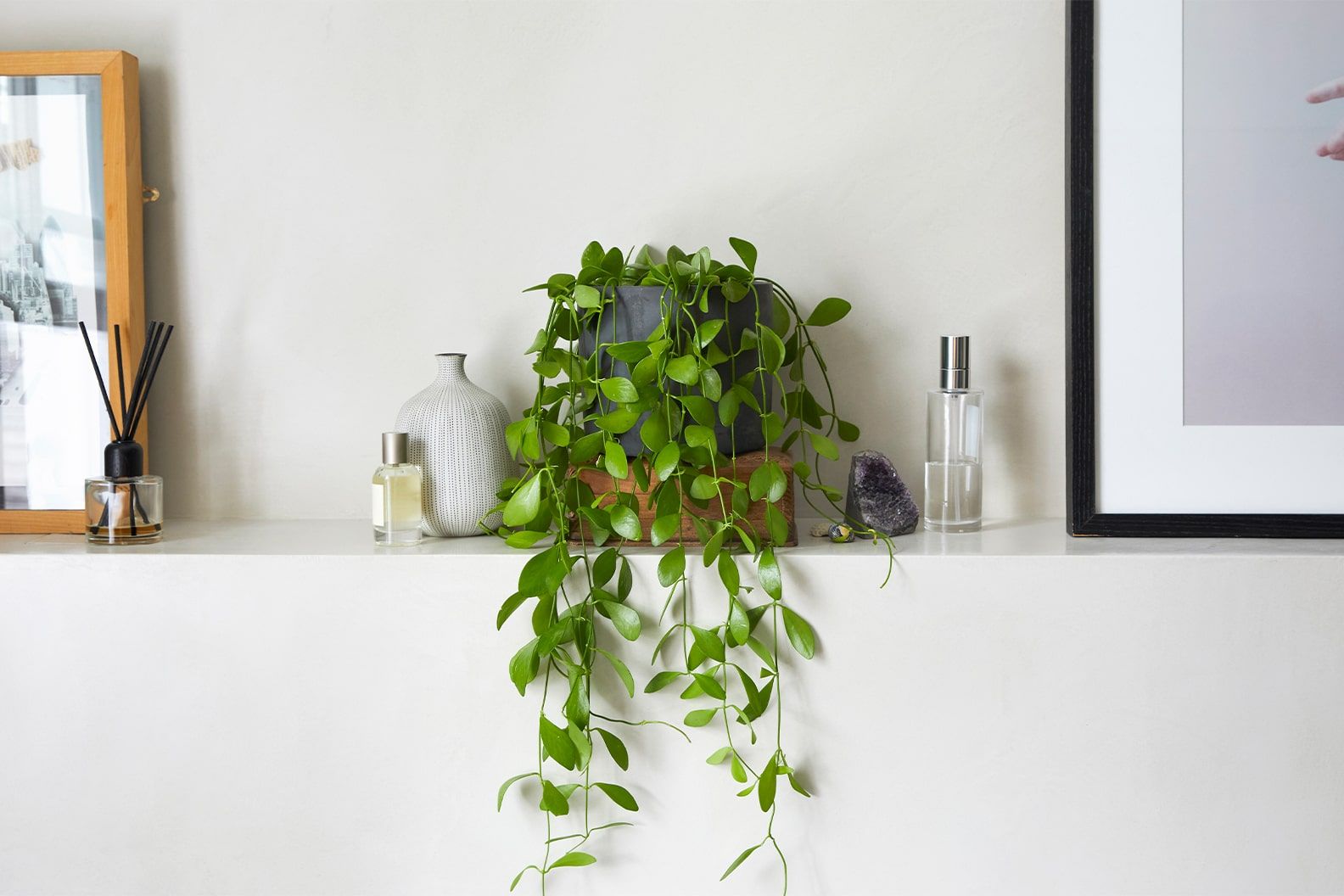 String of nickels in a black clay pot on a shelf in a bathroom