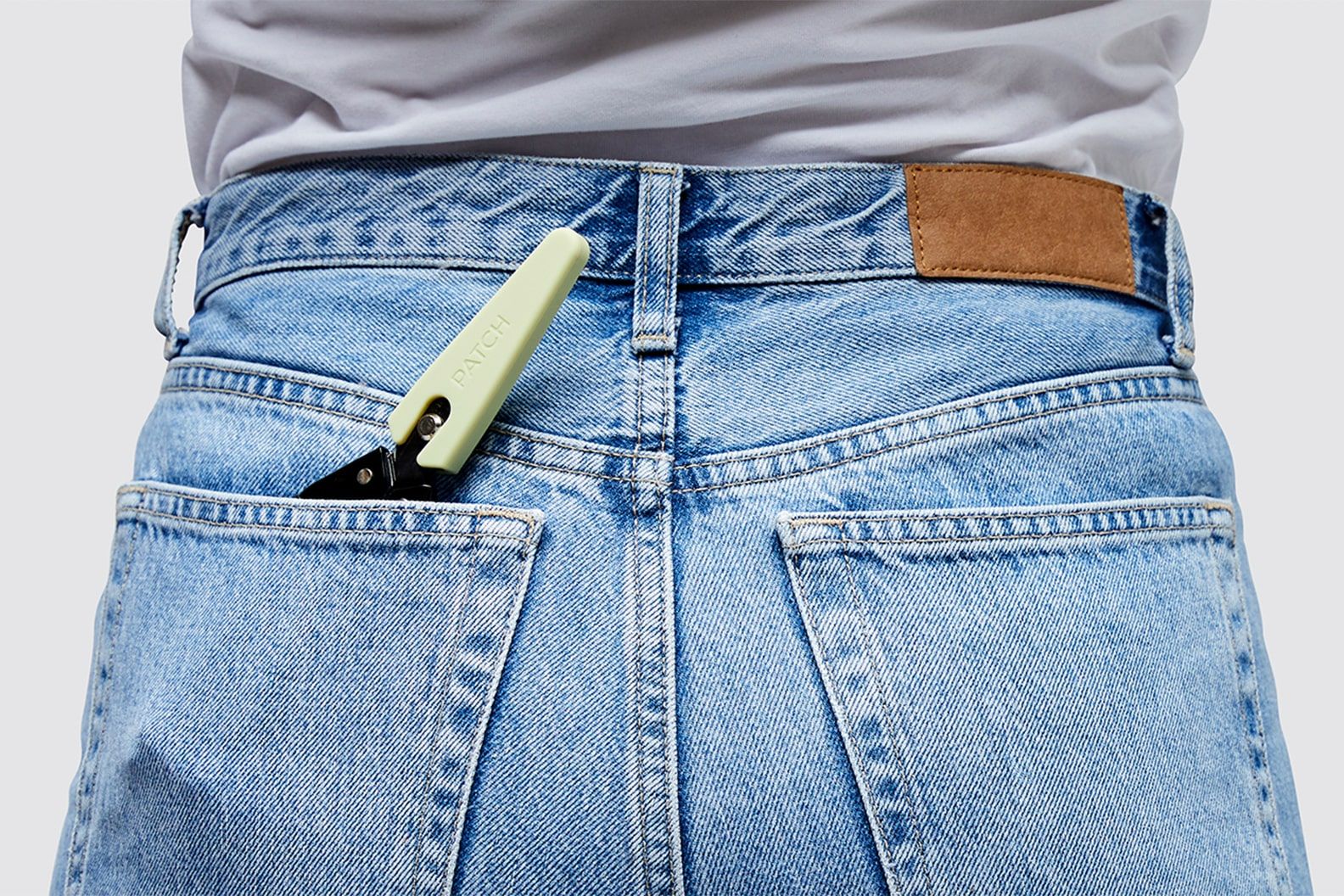 Patch branded secateurs peeking out of the top of the back pocket of a pair of jeans