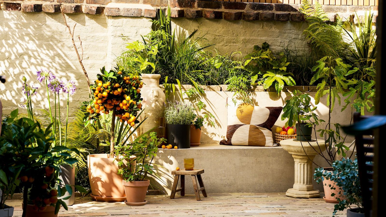 A Mediterranean-inspired garden with fruit trees, flowering plants and ornamental grass