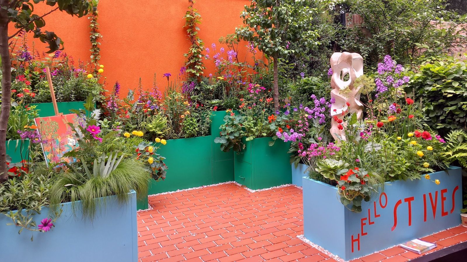 Blue and green planters are filled with a colourful display of wildlflowers for the Seasalt Balcony Garden